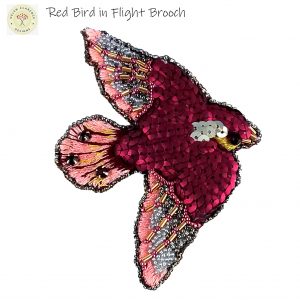 red bird in flight brooch